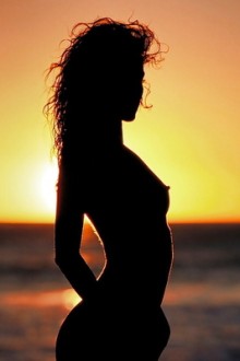 Beautiful silhouette of Monique Alexander on beach