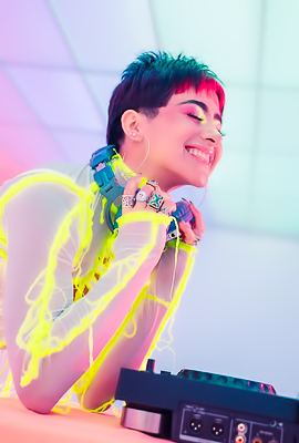 Mia Valentine grooves energetically, vibrating through her neon lingerie in neon-lit studio art