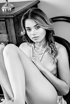 Keira Blue stretches across the table, exposing herassets and teasing a striptease